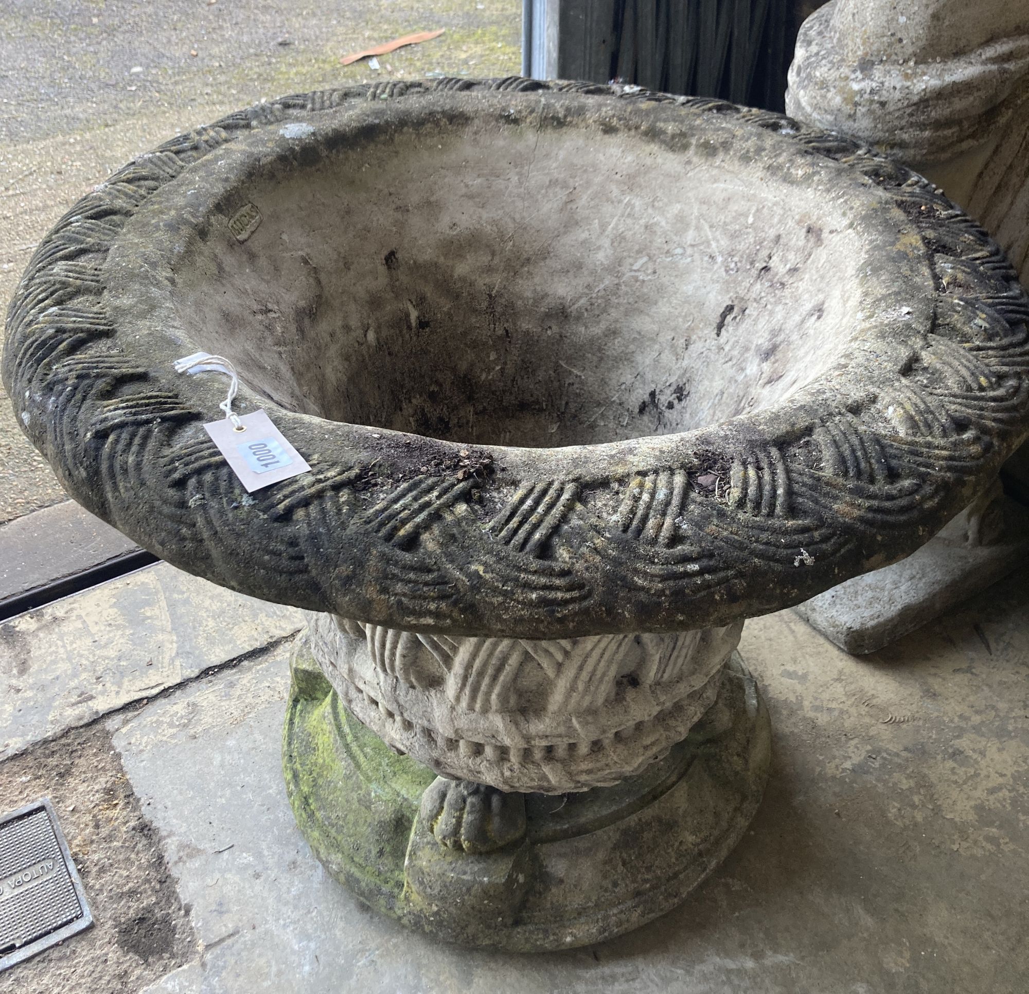 A large Lucas reconstituted stone garden planter on lions paw plinth foot, diameter 74cm, height 60cm